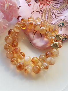 Love this gorgeous Citrine with its Cognac colours and its delightful citrine clouds, just so pretty! This Citrine gemstone bracelet will delight you its gorgeous colours, each individual citrine bead is so special and unique. I have used size 10mm Cloudy Citrine beads in this lovely bracelet and this charming Bracelet features a Gold plated Heart bead making a beautiful focal peace. The bracelets are approximately 19cm.  Citrine is a beautiful gemstone with beautiful energy, regarded as a spiri Spiritual Citrine Bracelet As A Gift, Citrine Bracelets With Natural Stones For Gift, Citrine Bracelets With Natural Stones As Gift, Citrine Gemstone Beads Crystal Bracelet As Gift, Citrine Gemstone Beads Bracelet As Gift, Amber Gemstone Beaded Bracelet As Gift, Amber Gemstone Beads Crystal Bracelet As Gift, Amber Crystal Bracelet With Gemstone Beads As Gift, Amber Gemstone Beaded Bracelets As Gift