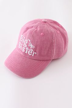 a pink baseball cap with the words big sister embroidered on it's front side