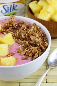 there is a bowl of fruit and yogurt on the table