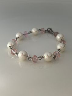 8mm White shell pearl and 5x6 pale pink crystal glass beads, silver stainless steel with a small lobster claw closure. Available in 6" and 7 inches.  Hand made jewelry!  All purchase will arrive in gift boxes  Thanks for stopping by! Pearl Bracelet Ideas Diy, Elegant Pink Crystal And Pearl Bracelet, Elegant Pink Pearl Crystal Bracelet, Pink Pearl Jewelry With 8mm Beads, Elegant Pink Pearl Bracelet With 8mm Beads, Adjustable Pink Pearl Bracelet With Pearl Drop, Bronze Necklace, Diy Bracelet Designs, White Bracelets