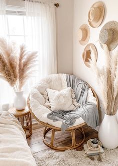 a room with several hats hanging on the wall and a chair in front of it