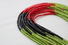 Red, black, and green traditional waist beads hand crafted in Ghana. ♥️🖤💚Strung on cotton string with no clasp.Made with glass seed beads. Fits up to 42 INCHES Comes with one strand Bead Size - Small Traditional Green Multi-strand Beads, Traditional Black Beaded Necklaces With Spacer Beads, Traditional Hand-strung Waist Beads For Festival, Traditional Black Beaded Bracelets With Tiny Beads, Green Beaded Necklaces With Black Beads For Festivals, Green Beaded Necklace With Black Beads For Festivals, Green And Black Beaded Necklaces For Festivals, Green Beaded Necklace With Black Round Beads, Traditional Green Beaded Bracelets With Spacer Beads