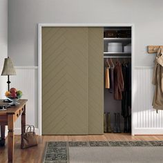 an open closet with clothes hanging on the wall and a coat rack in front of it