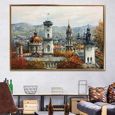 a painting hanging on the wall above a couch in a room with furniture and decor