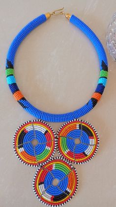 African Bush Blue Zulu Pendant Necklace, African Beaded Necklace, African Jewelry, Tribal Necklace, Gift For Her, Women Jewelry, GiftThis stunning beaded pendant necklace is elegantly crafted.Main Color - Bush Blue.Available is different colors.Wholesale available at a fair price.For any clarification please send me a convo or an e-mail.Thank you for visiting and Happy Shopping!!.. Traditional Blue Necklaces With Tiny Beads, Traditional Blue Necklace With Tiny Beads, Blue Tiny Beads Round Jewelry, Blue Round Jewelry With Tiny Beads, Blue Necklaces With Colorful Round Beads, Blue Beaded Necklaces With Spacer Beads, Blue Beaded Necklaces With Colorful Beads, Blue Round Beaded Necklaces With Colorful Beads, Blue Beaded Round Necklaces