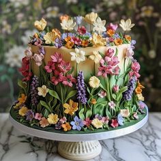 a cake decorated with flowers on top of a table