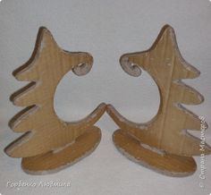 two wooden ornaments made to look like christmas trees