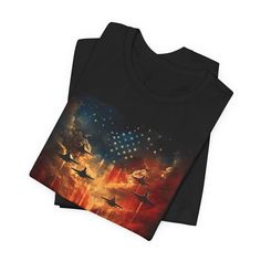 Elevate your wardrobe with a powerful statement in fashion — the "Freedom Flight: Patriotic Skyline T-Shirt" embodies the spirit of liberty and the thrill of the skies. This exclusive tee features a bold and vivid print that captures the essence of valor with a stunning display of fighter jets soaring across a star-spangled sky, blended seamlessly into a striking sunset. Each shirt is a canvas of heroism, designed to evoke pride and a sense of unity in every thread. Crafted for comfort and style Black Graphic Tee With American Flag Print, Black Patriotic T-shirt For Summer, Patriotic Black T-shirt For Summer, Patriotic Black Crew Neck Shirt, Black Patriotic Summer T-shirt, Black Patriotic Crew Neck Shirt, Black T-shirt With American Flag Print For Summer, Black Graphic T-shirt For Independence Day, Black Crew Neck Patriotic Shirt