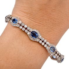 Walser Wald Vintage Deco Diamond Sapphire Platinum Bracelet Presenting a gorgeous Vintage Art Deco Bracelet crafted in Platinum with Natural Diamonds and Sapphires. In a two-row Oval link Design the gemstone and Diamonds are bezel and Prong set to perfection.  It is secured with an Insert clasp and a chain with a spring ring. Diamond total Carat weight approx: 5.70 cttw Clarity Grade approx: F-G Color Grade approx: VS2-SI1 Set with nine bezel-set sapphires, weighing approx: 14.50  cttw Bracelet Luxury Multi-stone Diamond Bracelet For Formal Occasions, Luxury Oval Multi-stone Tennis Bracelet, Luxury Multi-stone Tennis Bracelet For Formal Occasions, Elegant Multi-stone Platinum Gemstones, Elegant Multi-stone Oval Tennis Bracelet, Elegant Oval Multi-stone Tennis Bracelet, Elegant Multi-stone Diamond Bracelet, Elegant Diamond Multi-stone Bracelets, Elegant Multi-stone Diamond Bracelets