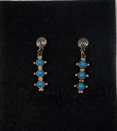 "Native American style handmade snake eyes earrings with bright blue round turquoise. Snake eyes are small round pieces of turquoise set in rows. The earrings start with a small silver stud and dangling below is a line of turquoise snake eyes. Great southwestern look. Please note that the earrings themselves were acid tested to be sterling silver, but the posts are NOT sterling. If you are sensitive to nickel, please don't buy these earrings. Vintage 1970's circa Designer Brand - None, unmarked. Southwestern Style Blue Earrings For Pierced Ears, Southwestern Blue Earrings For Pierced Ears, Southwestern Style Blue Pierced Earrings, Nickel-free Blue Southwestern Earrings, Snake Eyes, Native American Style, Southwestern Jewelry, Native American Fashion, Eye Earrings