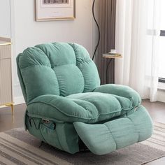 a blue recliner chair sitting on top of a rug