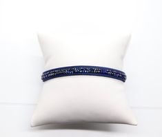 This blue and black diamond bracelet is the perfect accessory for any occasion. It's made of genuine gemstones and is sure to turn heads. Elegant Blue Wrap Bracelet As Gift, Elegant Blue Wrap Bracelet As A Gift, Elegant Adjustable Blue Bracelets, Elegant Blue Adjustable Leather Bracelet, Elegant Adjustable Blue Leather Bracelet, Elegant Blue Leather Bracelet For Gift, Adjustable Blue Party Bracelets, Elegant Adjustable Blue Cuff Bracelet, Adjustable Blue Cuff Bracelet For Party