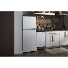 a white refrigerator freezer sitting inside of a kitchen