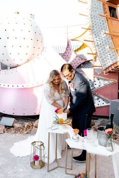 🌟 Capturing the charm of a Neon Museum wedding, this intimate cake-cutting moment is everything! The bride's high-waisted wedding dress with lace details and the groom's spirited style perfectly match the quirky, vibrant backdrop. 🍰✨ A scene filled with unique wedding ideas, elegant dresses, and heartfelt smiles! Click to explore more wedding fun! #WeddingCake #UniqueWeddingIdeas #WeddingDresses #WeddingHairstyles #WeddingRings Las Vegas Wedding Dresses, Wedding Ideas Elegant, Desert Weddings, Vegas Wedding Dress