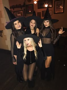 four women dressed up as witches posing for the camera