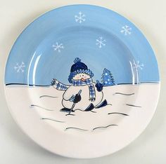 a blue and white plate with a snowman on it