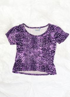 This Y2K vintage baby has the eclectic energy of a teenage rave with its purple leopard pattern. Go on, let your fashion freak flag fly! Features: - 95% viscose, 5% elastane - stretchy Every item we manage is cleaned and, when necessary, repaired, ensuring it arrives to you in top condition. Size: XL / US 10 / UK 14 / IT 46 Other size info: Labelled size: XL Measurements:  width (seam to seam): 51 cm / 19.9" sleeves: 16 cm / 6.2" length: 52 cm / 20.3" Fabric: viscose 95%, elastane 5% Care: Machi Purple Leopard Print, Purple Animals, Purple Leopard, Y2k Baby Tee, Crop T Shirt, Leopard Pattern, Crop Tshirt, Vintage Baby, Baby Tshirts