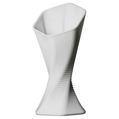 a tall white vase with wavy lines on the bottom and sides, sitting in front of a white background