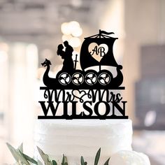 a wedding cake topper with a silhouette of a bride and groom in a boat