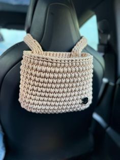 a car seat with a basket hanging from the back