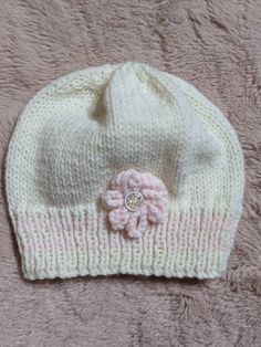 A lovely cream, hand knitted hat with pink flower and stripe details.  Lovely and soft for extra comfort  Ideal for 0-3 months  Wash at 40o Cute Soft White Hat, Cute White Knitted Bonnet, Cute White Knitted Beanie, Cute Cream Knitted Hats, Cute White Knitted Hat, Cute White Soft Knit Beanie, Cute Cream Soft Knit Hat, Hand Knitted White Hat Gift, White Hand Knitted Hat As Gift