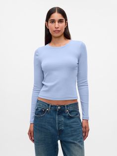 Soft, stretch cotton-modal blend ribbed T-shirt.  Crewneck.  Long sleeves.  Fit: Stretch-to-Fit.  Slim & stretchy that forms to your shape.  Hits at the waist.  Models wearing Gap Cheap Light Blue Gap Tops, Slim Fit Long Sleeve Light Blue Top, Gap Long Sleeve Blue Tops, Blue Fitted Cropped T-shirt, Cheap Blue Stretch Cropped T-shirt, Brand Collaboration, Cropped T Shirt, Blue Top, Crop Tshirt