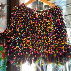 a black sweater with colorful sprinkles on it