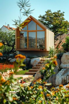 the house is surrounded by rocks and trees