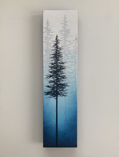 the painting is hanging on the wall in front of the white wall and there are two tall pine trees