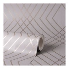 a white wallpaper with silver lines on it and a roll of tape next to it