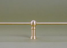 a metal pole with a ball on it and a long bar in the middle is shown