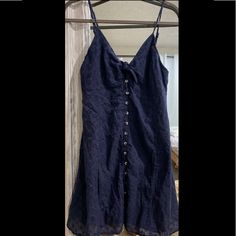 Nwt Navy Blue Flowy Dress With A Bow In The Front And Small Flower Print All Over. Buttons Go Down The Middle Of The Dress With An Extra Button Provided. The Straps Are Adjustable And The Back Has A Section Of Stretch Material. Fits Like A Large And Hits Right Above The Knees. Blue Button-up Mini Dress For Vacation, Navy Summer Dress With Button Closure, Blue Dress With Button Closure For Date Night, Blue Sundress With Button Closure, Blue Mini Dress With Button Closure For Summer, Blue Mini Dress With Buttons For Day Out, Blue Button-up Summer Dress, Blue Sleeveless Mini Dress With Buttons, Blue Buttoned Summer Dress