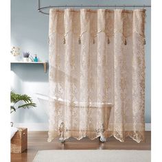 a bathroom with a shower curtain and rug