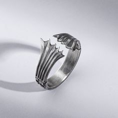 Fly into a fantasy world with the Dragon Wings Men's Ring. This intricately engraved sterling silver ring features exquisite oxidized detailing of a majestic dragon in flight, spreading its wings across the band. The gothic yet refined design makes this ring a unique gift for the daring man with an eye for dark elegance. Slip on this lightweight, comfortable ring daily as a symbol of your man's strength, courage, and free spirit. Whether he's a series fan or loves mystical creatures, this handma Gothic Metal Rings For Collectors, Gothic Collectible Metal Rings, Gothic Metal Rings, Gothic Hand Cast Metal Rings, Gothic Claw Shaped Metal Rings, Gothic Claw Rings As Gift, Fantasy Style Silver Rings Made Of Metal, Fantasy Style Silver Metal Rings, Majestic Dragon