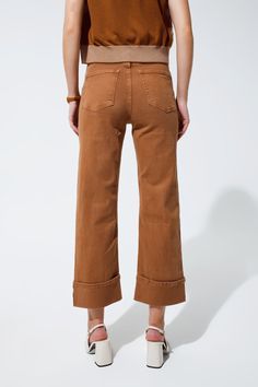 Introducing the epitome of versatile fashion: our Straight Leg Jeans in a rich camel hue. These jeans blend the timeless straight-leg silhouette with contemporary folded trouser legs, creating an effortless style that can transition from daytime casual to evening sophistication. Constructed with a blend of 98% Cotton and 2% Elastane, these jeans offer both comfort and durability. The stretch denim ensures a snug fit that moves with you, while the five-pocket design provides ample space for your Types Of Jeans, Trouser Design, Free Dresses, Straight Leg Denim, Men Shirt Style, Pocket Design, Women's Fashion Dresses, Effortless Style, Stretch Denim