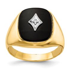 a gold ring with black onyxite and white diamond in the center, set against a white background