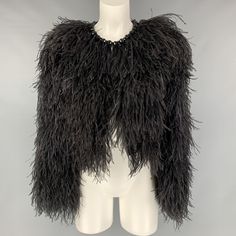 SAN FRANCISCO'S FAVORITE DESIGNER CONSIGNMENT STORES AND ONLINE SHOP GIVENCHY Size 4 Black Silk Feathers Ostrich Cropped Jacket IN-STORE ID: 116572 GIVENCHY cropped jacket comes with a black silk ostrich feather featuring a round neck, a hook & eye fastening, an open front, and a gemstone embellished at neckline. New with Tags. Marked: 38 Measurements: Shoulder: 17 in. Bust: 39 in. Sleeve: 24 in. Length: 20.5 in. Original Retail Price (if known): $4,990.00 Category: Jacket (Outdoor) More Details Feathered Long Sleeve Evening Outerwear, Formal Feathered Outerwear For Winter, Long Sleeve Evening Outerwear With Feathers, Evening Long Sleeve Outerwear With Feathers, Formal Black Outerwear With Feather Trim, Black Formal Outerwear With Feather Trim, Luxury Outerwear With Feather Trim For Parties, Luxury Feather Trim Formal Outerwear, Evening Feather Trim Faux Fur Outerwear