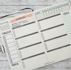 an open planner sitting on top of a wooden table