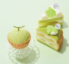 two pieces of cake sitting next to each other on top of a glass plate with an apple in the middle