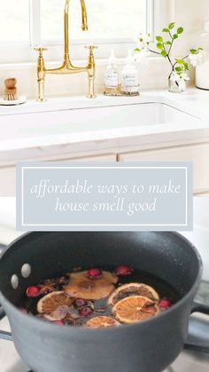 a pan filled with food sitting on top of a stove next to a kitchen sink