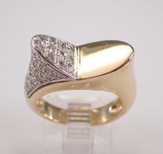 Vintage Estate 14K Yellow Gold Diamond Ring. Diamond Specifications: Shape: Round Brilliant Amount: 36 diamonds Color: H (colorless) Clarity: SI (eye clean) Carat Weight: .35 carat Metal Specifications: Type: 14K Yellow Gold Weight: 6.5 grams Measurement: 8 mm Finger Size: 5 (Free Sizing, please inquire) Additional Information: Authenticity Certified Appraisal with Retail Replacement Value $2,075.00 included Free Gift Box Free Shipping ADDITIONAL REQUESTS If you would like to see more pictures of this item, please let us know and we would be happy to provide them for you. Please contact us with all questions, we are here to help. Designer Formal Diamond Ring With Single Cut Diamonds, Designer Diamond Ring With Pave Setting For Formal Events, Designer Formal Diamond Ring With Accents, Formal Marquise Diamond Ring With Pave Setting, Diamond Ring Unique, Yellow Gold Diamond Ring, Unique Diamond Rings, Gold Diamond Ring, Ring Diamond