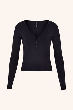 Meet our Cozy Long Sleeve Top: the perfect companion to our beloved Cozy Shorty. This ultra-soft, body-fitted top features a flattering V-neckline and delicate buttons. Ideal for layering or wearing solo, it transitions effortlessly from lounging at home to stepping out in style. The snug fit and breathable fabric make it a staple for any season, ensuring you stay comfortable and chic. Ultra-soft and body-fitted Classic henley design with V-neckline Delicate button detailing Snug yet breathable Black Long Sleeve Henley, Swan Aesthetic, 2000s Clothing, 2000s Outfit, Clothes Wishlist, Bella Swan, Long Sleeved Top, Fall Clothes, Black Long Sleeve Top