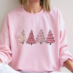 Pink Tree Christmas Sweater, Christmas Sweater, Christmas Crewneck, Christmas Tree Sweatshirt, Holiday Sweaters for Women, Winter Sweatshirt Thank you so much for taking the time to browse my shop. All of our items are just for you. Please feel free to reach out if you have any questions before or after purchasing.   We provides the highest quality fabrics and materials. Non-toxic vinyl is used in the design of the shirts. Our vinyl has been certified by "REACH", "Oeko-Tex® Standard 100 Class I" Pink Tree Christmas, Sweaters For Women Winter, Christmas Tree Pink, Holiday Sweaters, Christmas Tree Graphic, Pink Tree, Christmas Crewneck, Pink Trees, Pink Christmas Tree