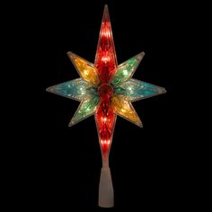 a lighted christmas star ornament with multicolored lights on it's side