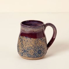 a brown and blue coffee mug sitting on top of a table