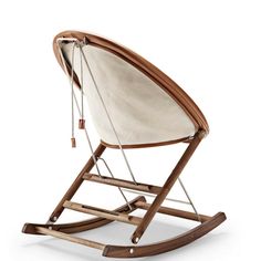 a wooden rocking chair with white fabric on it