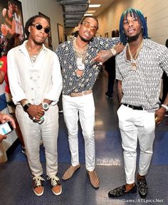 three young men standing next to each other