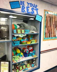 a display case filled with lots of toys in a store's front window that says be your best