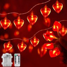 a string of red heart shaped lights next to a remote control