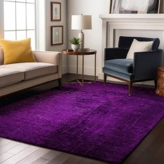 a living room filled with furniture and a purple rug